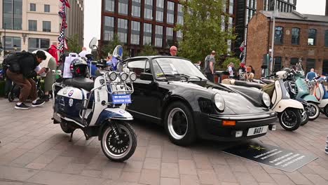 Capturing-pictures-and-videos-of-the-Porsche-and-Vespa-within-St-Pancras,-London,-United-Kingdom