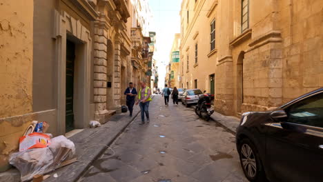 POV-handheld-shot-walking-in-the-middle-of-a-narrow-street-in-Valletta