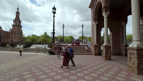 Slow-motion-POV-shot-of-people-walking-through-Spain-Square-in-Seville