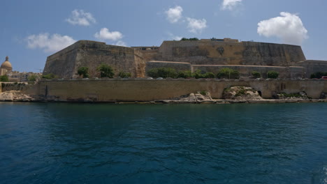 Trucking-shot-of-an-old-coastal-defense-fortification-in-Valletta-Malta