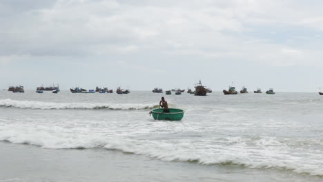 Panorámica-Aérea-A-La-Izquierda-Del-Tradicional-Barco-Coracle-Rebotando-Sobre-Las-Olas,-Vietnam