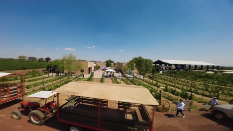 From-a-drone-perspective,-the-event-unfolds-in-Ecatepec-de-Morelos,-Mexico,-Participants-are-uniformly-attired-in-white,-A-selection-of-traditional-farm-vehicles-can-be-observed-parked