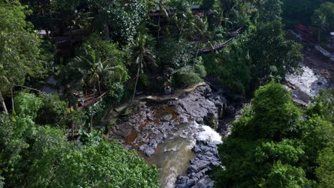 Tegenungan-Waterfall-Surrounded-With-Lush-Vegetation-In-Bali,-Indonesia---aerial-shot