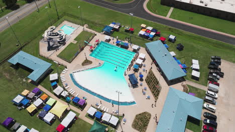 Aerial-View-Of-Swimming-Pool-At-Swim-Club-In-Siloam-Springs-During-Summer-Swim-Meet-In-Arkansas,-USA