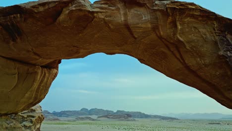 Red-Rock-Formation-In-Wadi-Rum-Desert-Of-Jordan---aerial-pullback