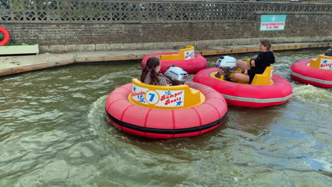 Children-playing-in-bumper-boats-on-the-water-at-a-holiday-theme-park