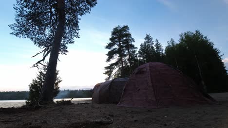 Timelapse-of-tent-in-finnish-lapland,-camping-in-wilderness-by-lake