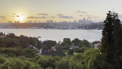 Sun-sets-behind-clouds-and-Istanbul-Bosphorus-Bridge-with-Turkish-skyline