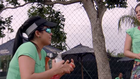 sporty-women-taking-a-break-to-hydrate,-drink-water-and-have-a-chat,-mother-daughter-workout