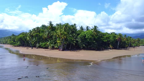 Aerial-view,-people-walking-over-beach-in-National-Park-of-Marino-Bellena,-Costa-Rica