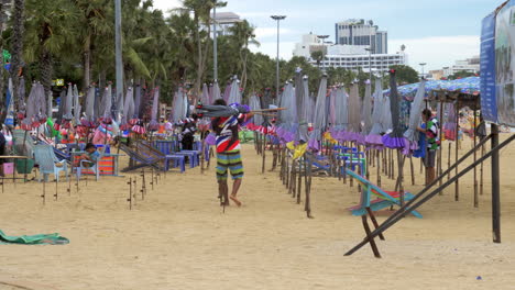 Beachside-cafe-workers-remove-beach-umbrellas-for-tourists-to-shade