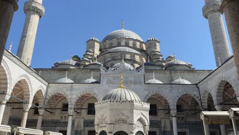 Push-in-between-pillars-to-reveal-center-of-Suleymaniye-Mosque-at-midday