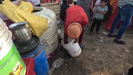 A-person-is-washing-a-plastic-bucket-with-water