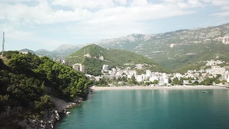 drone-approaching-scenic-coastline-in-Adriatic-Sea-near-Bečići-town-in-the-municipality-of-Budva,-Montenegro