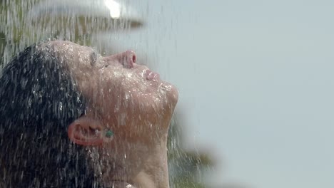 Mujer-Duchándose-En-La-Playa,-Primer-Plano-De-La-Cabeza,-Cabello-Oscuro-Latino,-Arete,-Manos-A-Través-Del-Cabello,-Lavarse-El-Cabello