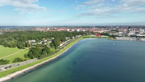 Aarhus-Denmark-panoramic-cityscape-aerial-and-establishing-scene---Seen-with-Marselisborg-beach-in-foreground