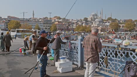 Man-catches-fish-on-Galata-bridge-with-Istanbul-skyline-backdrop