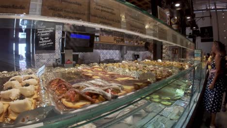 Madrid,-Spain:-The-Mercado-de-San-Miguel-is-a-treasure-trove-of-Spanish-culinary-delights,-we-bring-you-a-tantalizing-glimpse-of-its-tapas,-cheeses,-olives,-and,-of-course,-the-delicious-jamón