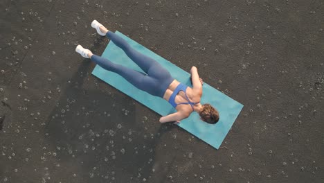 Bird's-ey-view-of-a-fit-woman-doing-push-ups