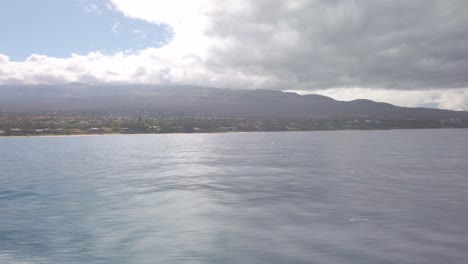 Gimbal-panning-POV-shot-from-a-moving-boat-of-Haleakala-and-Wailea-from-Molokini-Crater-in-Hawai'i