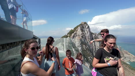 Slow-motion-shot-of-people-enjoying-the-view-from-a-skywalk-in-Gibraltar
