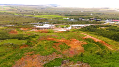 Aerial-establishing-shot-of-steam-escaping-the-ground-in-geothermal-region-in-Iceland