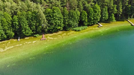 Shoreline-of-typical-kashubian-lake-of-Jezioro-Gwiazdy-in-Borowy-Młyn-in-Kashubia,-Pomeranian-Voivodeship,-Poland