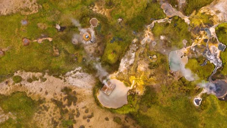 Aerial-shot-overhead-steam-escaping-through-the-ground-in-the-geothermal-region-in-Iceland