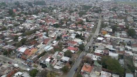Panoramic-drone-shot-of-Villa-Fiorito-city,-Overcrowded-slums-in-Argentina-capital-under-hazy-sky-due-to-climate-change