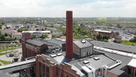 Aerial-orbit-shot-of-the-chimney-in-Arche-Hotel-Żnin-inside-old-sugar-factory-in-Poland