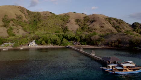 Komodo-aerial-of-the-beach-and-reef-on-a-hot-sunny-day-at-sunset