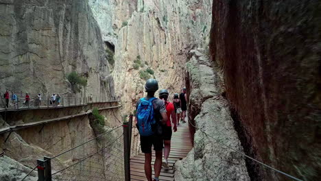 Adventurous-explorers-wear-helmets-walking-along-footpath-and-cables-of-Observatorio-ornitologico-el-cabrito