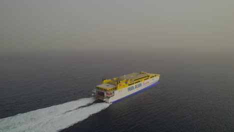 Aerial-view-of-the-ferry-that-turns-to-its-destination-on-a-day-with-a-lot-of-haze-in-the-atmosphere
