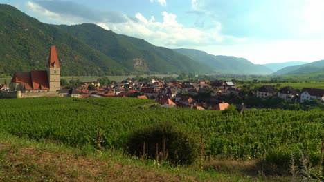 Beautiful-Panorama-and-Church-of-old-town-of-Weisskirchen,-in-the-Wachau-region-of-Austria-with-Danube-River-in-Background