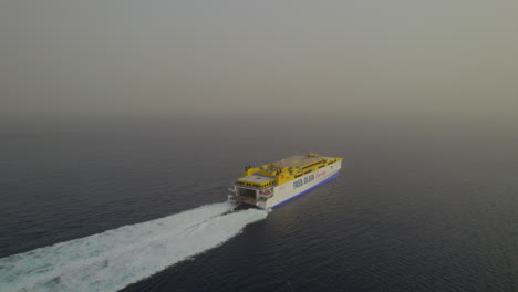 Aerial-view-in-orbit-of-a-ferry-sailing-on-a-day-with-a-lot-of-haze-in-the-air