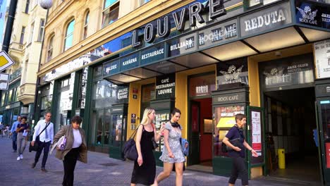 Café-Louvre-old-cafe-and-monument-of-more-than-100-years-old-in-Prague,-front-area-with-pedestrians-passing