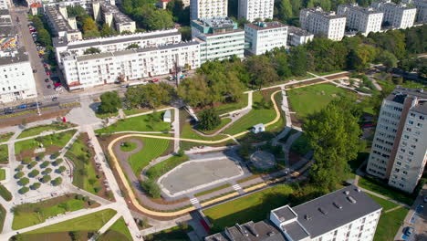 Aerial-establish-pullback-above-Park-Centralny,-Gdynia-Poland-on-sunny-day
