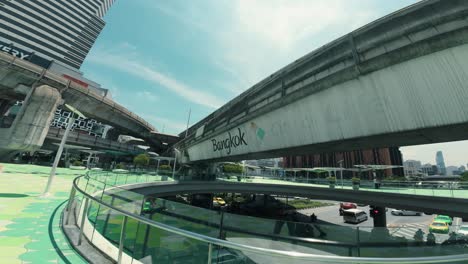 View-of-a-bridge-with-'Bangkok'-written-on-it-in-the-city,-with-cars-passing-underneath