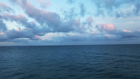 Seascape-and-pink-clouds-over-Varazze-city-in-Liguria-at-sunset,-Italy