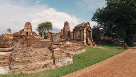 Exploring-the-renowned-ancient-walls-and-ruins-of-Bangkok,-where-an-enthusiastic-tourist-captures-memorable-moments-with-her-camera