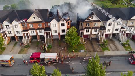 Bomberos-Extinguiendo-Un-Incendio-En-Una-Casa-En-Toronto,-Canadá,-Durante-El-Día.