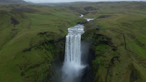 Beautiful-aerial-view-from-Skogafoss-waterfall-in-Iceland-and-Skoga-river-during-summer-in-an-incredible-green-landscape