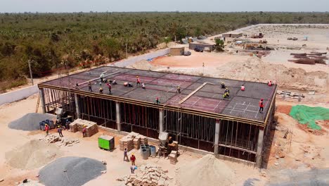 Aerial-view-of-control-and-switch-room-of-photovoltaic-power-plant-under-construction-in-Jambur,-Gambia---West-Africa