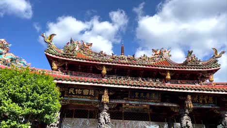Panorámica-Hacia-Abajo-Desde-La-Parte-Superior-Del-Templo-Longshan-Mientras-La-Gente-Se-Reúne-Frente-A-Las-Estatuas-Rezando