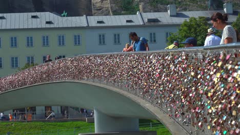 The-Marko-Feingold-Bridge-is-Full-of-Heart-Shape-Locks-While-People-Walks-and-Looks