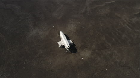 Drone-shot-of-crashed-plane,-circled-by-seagulls-in-the-middle-of-nowhere,-with-heat-waves
