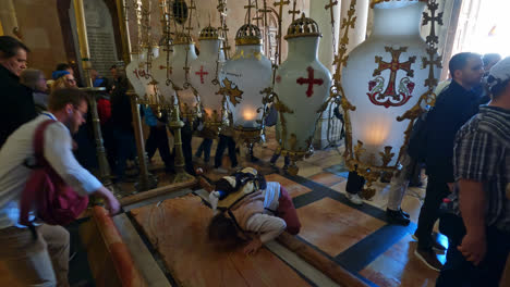 Christian-Pilgrims-Stopping-to-Pray-at-Stone-of-Anointing-in-Jerusalem,-Israel