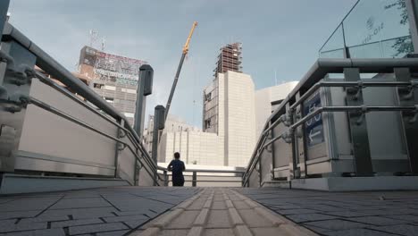 The-Nakagin-Capsule-Tower-Building-low-floor-angle-being-demolished-view-from-a-nearby-walkway