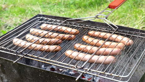 Bratwurst-sausages-cooking-on-a-wood-barbecue.