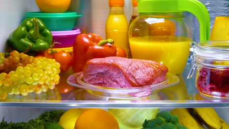 Fresh-raw-meat-on-a-shelf-open-refrigerator